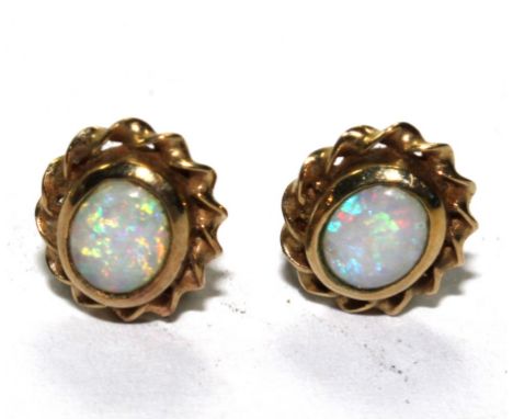 A small pair of gold and opal earrings 