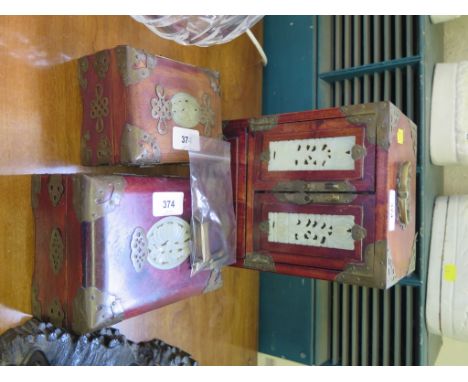 A Chinese hardwood table cabinet with brass fittings, inset with jade panels, 17.5 cm wide, 24.5 cm high, and two similar box