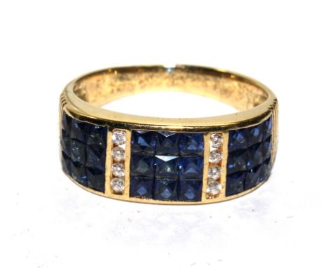 A ladies sapphire and diamond half hoop dress ring, with three panels comprising of three rows of three square cut sapphires 
