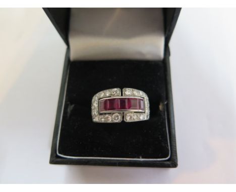 A diamond and ruby ring, in the form of a four row half eternity, the ring set with forty-four diamonds and five square cut r