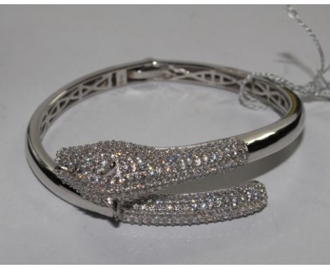 A 925 silver bangle with leopards head design and set with Swarovski stones, in J. McCarthy box 