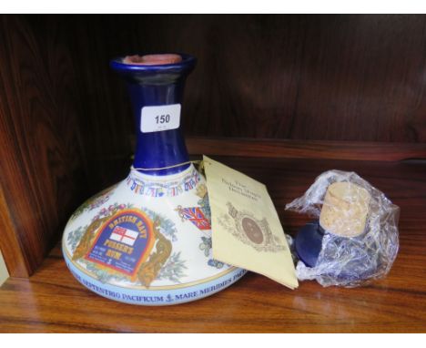 A commemorative bottle of British Navy Pusser's Rum, the bottle by Wade formed as a ship's decanter, sealed with wax, with as