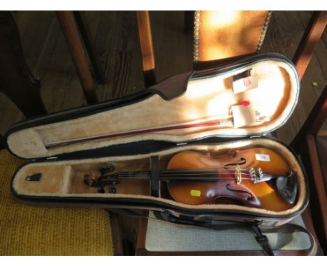 A violin, labelled 'Tatra by Rossetti, Stradivarius Model' Czechoslovakian, total length 55cm, cased with a bow. 