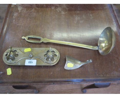 A brass pen tray, a brass ladle, and a brass shoe horn 