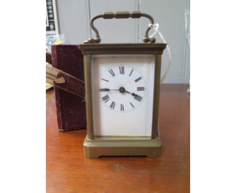 A brass carriage clock timepiece, of conventional form with enamel dial, and fitted case, 14 cm high 