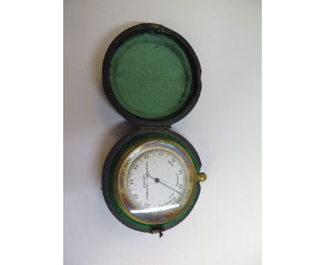 A pocket barometer by Negretti and Zambra, in a leather case 