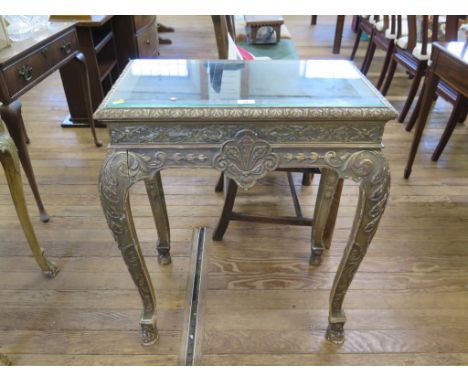 A George I style gilt wood console table, the glass top over a flowerhead diaper pattern frieze on acanthus carved square cab