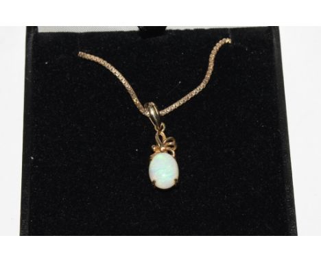 An opal pendant, set with 9 carat gold neck chain 