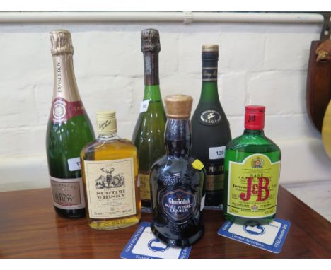 A bottle of Krug Grande Cuvee Brut Champagne; a bottle of Duval-LeRoy Premier Cru Champagne; a bottle of Remy Martin VSOP Cha