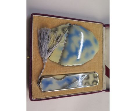 A boxed enamel ladies powder compact and matching comb 