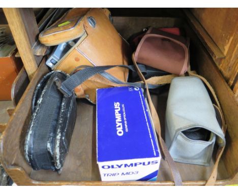 A Ross Ensign Selfix Snapper folding camera, a Polaroid 'The Button' camera, an Olympus Trip MD3 camera (in original box) and