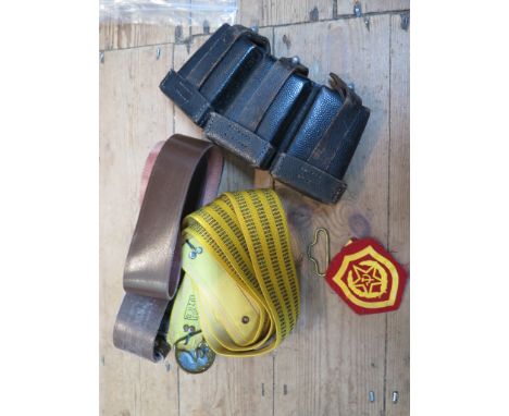 Two Soviet Union military belts both with brass buckles, two cloth badges, and a Second World War German leather ammunition p