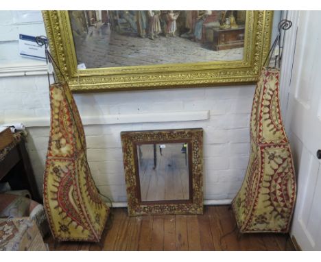 A pair of wavy form wrought iron and vellum floor standing lights, 145cm high, and a stone encrusted wall mirror (3) 