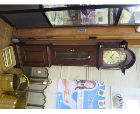 A mahogany longcase clock, the arched hood over a brass dial and glazed trunk door, the German movement striking on gongs, 18