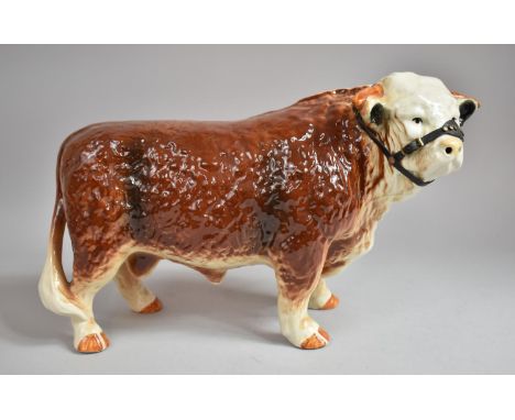 A Large Ceramic Study of a Hereford Bull with Leather Head Collar, 40cm Long 