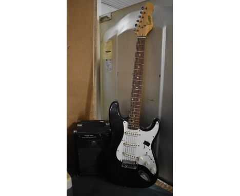 A Vintage Encore Electric Guitar and Realistic Portable Amplified Speaker System 