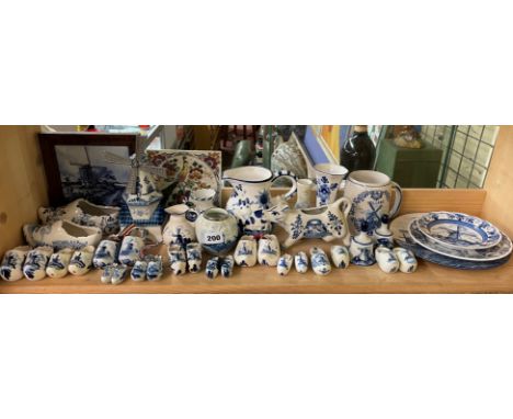 SHELF OF DUTCH DELFT BLUE AND WHITE POTTERY - CLOGS, COW CREAMER, JUGS, ETC