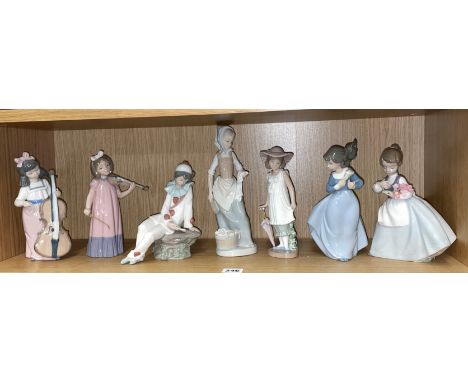 SHELF OF SEVEN NAO PORCELAIN FIGURES - GIRLS WITH INSTRUMENTS, PARASOL, AND FLOWERS 