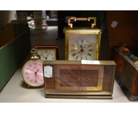 A group of four clocks including mid century Swiza and brass cased carriage clock by Time master