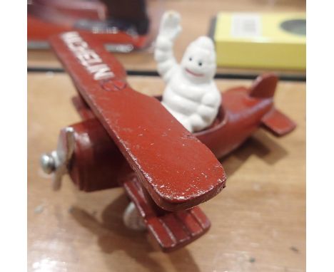 Cast iron Michelin Man in a plane, 10 x 11 cm. P&amp;P Group 1 (£14+VAT for the first lot and £1+VAT for subsequent lots) 