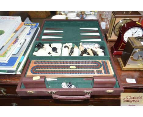 A boxed games set to include dominoes, chess pieces, Backgammon etc