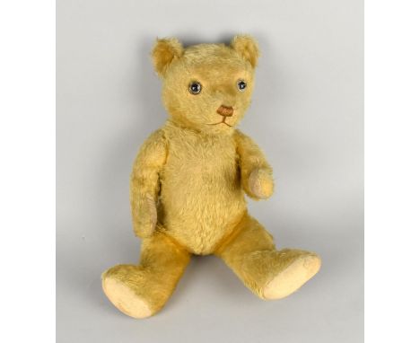 A Vintage Straw Filled Plush Teddy Bear with Glass Eyes, 44cms High