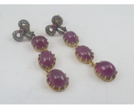 A PAIR OF CABOCHON RUBY AND DIAMOND BOW DROP EARRINGS each bow set diamonds and central small ruby 