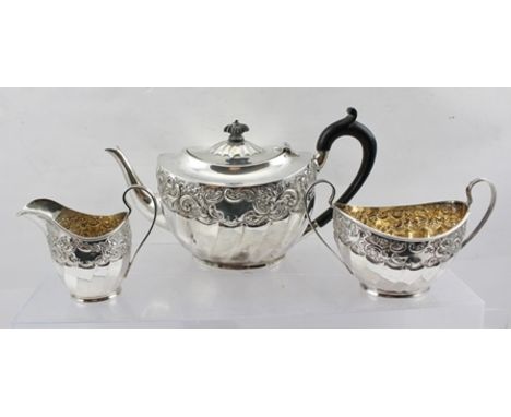 ZACHARIAH, BARRACLOUGH & SONS A LATE VICTORIAN THREE PIECE SILVER TEASET of Georgian bachelor form, having floral repousse an