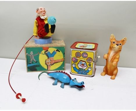 A TIN-PLATE JACK IN THE BOX together with remote control operated Clown, a resin model of a Corgi dog and a Triang tin-plate 