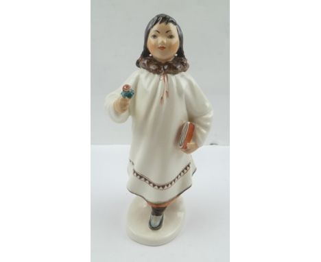 A 20TH CENTURY USSR CERAMIC FIGURE OF AN INUIT OR SIBERIAN GIRL, with book and flower, possibly Lomonosov factory, printed ma