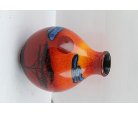 A LATE 20TH CENTURY POOLE POTTERY VASE of ovoid form, decorated with the "African Savanna" pattern on a graduated red/orange 