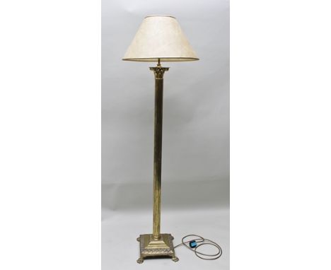 A BRASS FINISHED CLASSICAL COLUMN STANDARD LAMP, having mottled shade, on reeded column with stepped square base terminating 