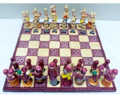 A 20TH CENTURY HAND-PAINTED CAST FIGURAL CHESS SET depicting stars of The Golden Age of Hollywood to include; Chaplin, The Ma