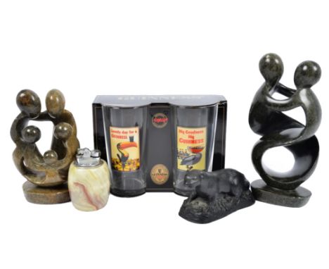 Two 20th Century carved soapstone sculptures, featuring entwined figures, together with a marble table lighter, a Classique m