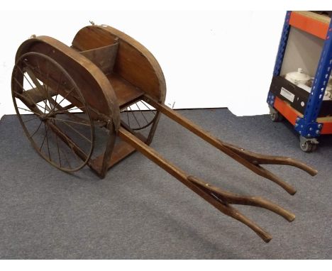 " A Victorian wooden Children’s play cart, with iron bicycle style wheels, having front and rear facing seats. Provenance: Us