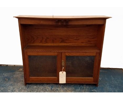 An early 20th Century oak wall cabinet, ebony and holly chequered inlay, one shelf above two glazed doors, with Harris Lebus 