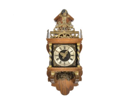 A pair of 20th Century clocks, consisting of a Dutch wall clock, dial with Roman numerals and flanked by brass twisted pilast