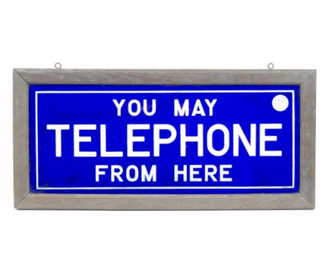 A rectangular enamel sign inscribed 'You may telephone from here', in white lettering on dark blue ground, framed, 21 x 36 cm
