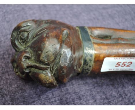 A treen walking stick having carved knop modelled as a dog with white metal collar with engraved Commemorative 1545