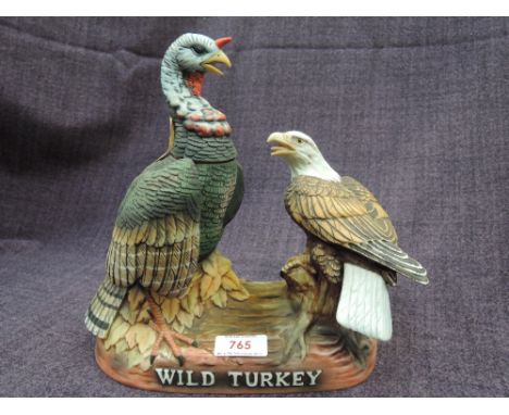 A Wild Turkey ceramic decanter of a Turkey and Bald Eagle fighting, 100% proof, 750ml, 8yr and unopened