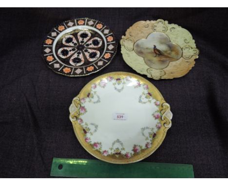 A Royal Worcester cabinet plate having blush ivory rim and handpainted cartouche depicting pheasant by Jas Stinton, a Royal C