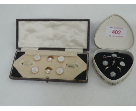 A cased set of three vintage silver and enamel buttons with matching bar brooch and another similar cased set of four yellow 