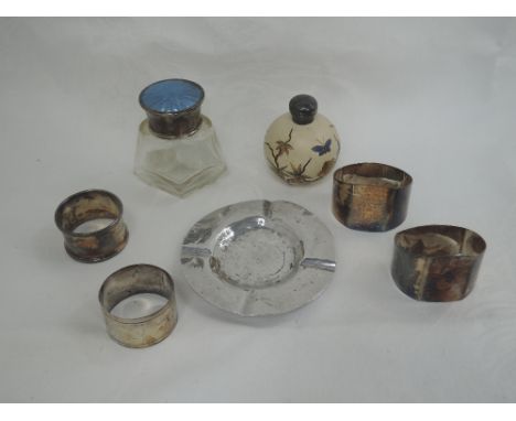 A small selection of HM silver including four napkin rings, a dressing table pot having blue guilloche enamelled lid, ceramic