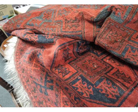 A 20th century carpet square of Turkmen style on red and black ground