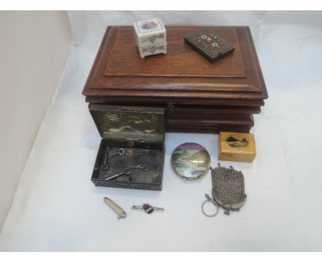 A wooden casket containing a selection of misc including ceramic ring box, treen souvenir thimble box depicting Aysgarth fall