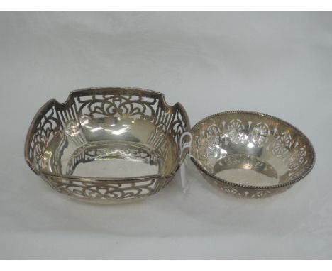 A small silver trinket dish having pierced decoration and beaded rim, Sheffield 1924, Walker & Hall, and another similar larg
