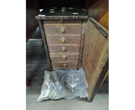 A stained pine tool chest containing a selection of vintage clockmakers tools
