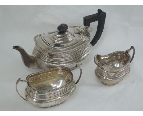 A three piece silver tea set of oblong form having reeded decoration, gadrooned rim and angular handles, Chester 1931, S Blan