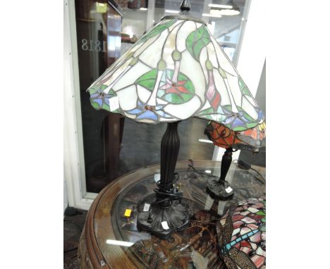 A Tiffany style reproduction table lamp having stylised shade with water lily decoration, in green