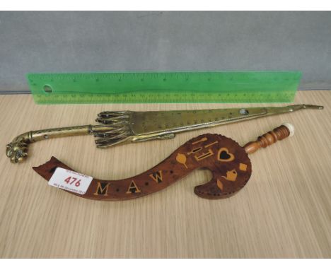 A yew wood knitting stick of traditional design having inlay decoration and a brass thermometer frame modelled as a parasol